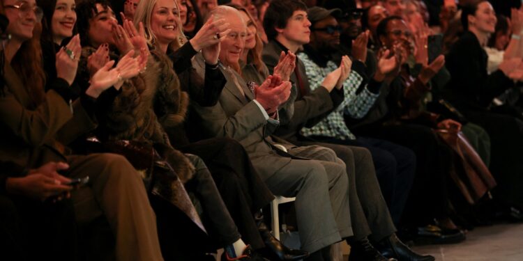Koning Charles schittert op modeshow na arrestatie broer Andrew in Londen